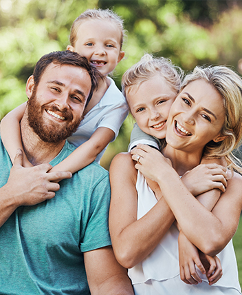 Smiling family enjoying quality time outdoors, representing ACA health coverage.