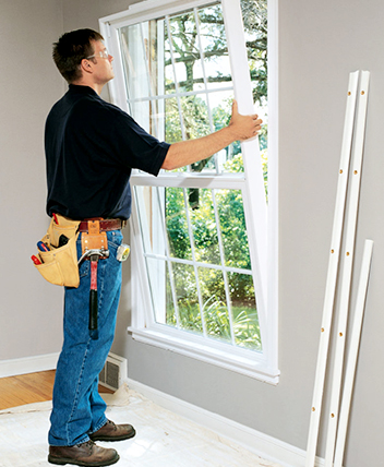 Technician installing a new energy-efficient window.