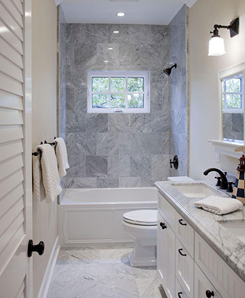 Modern bathroom with white vanity and marble finishes.